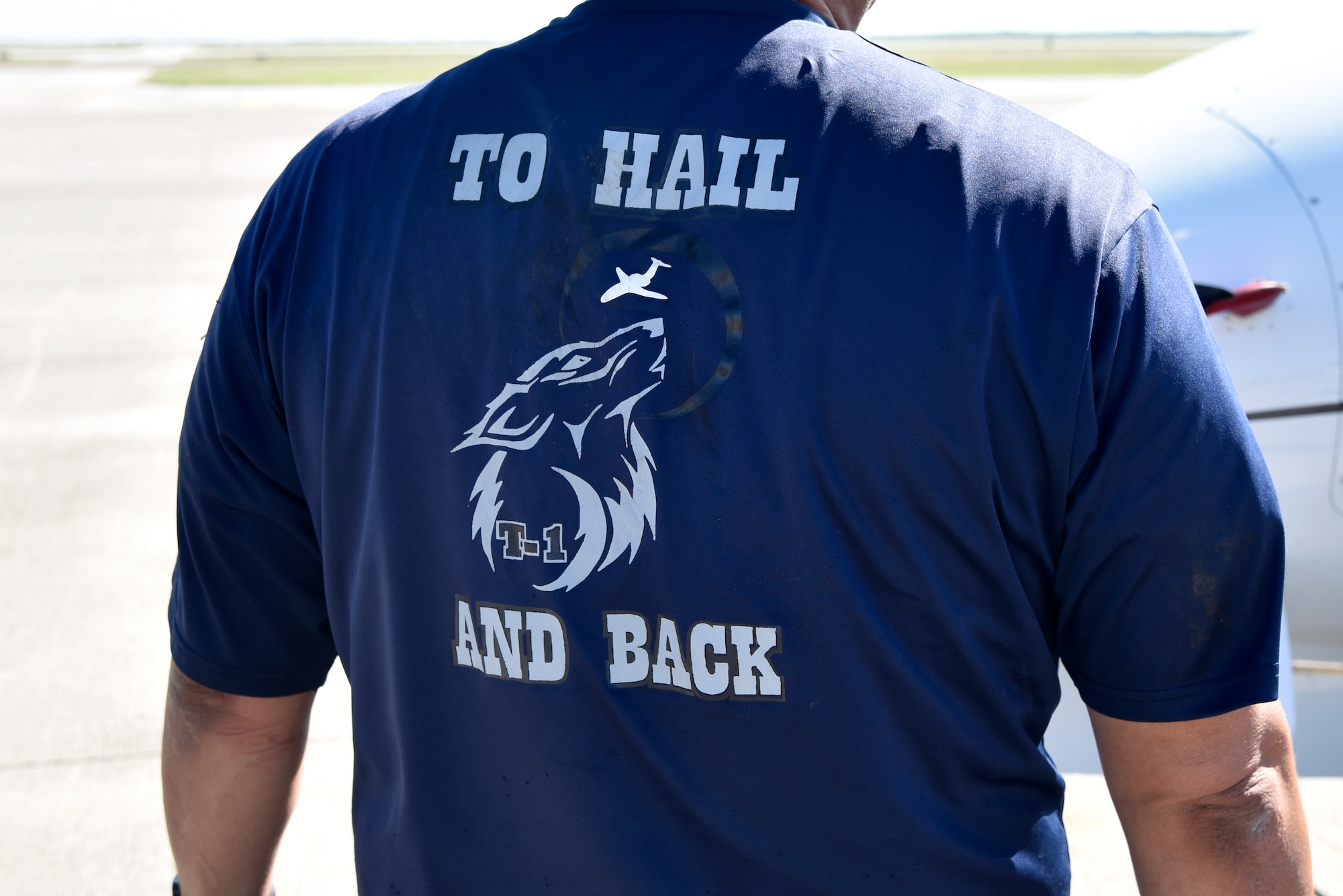 Ruben Luna, a 47th Maintenance Directorate T-1A Jayhawk aircraft worker, displays his commemorative work shirt of the 2016 hail damage at Laughlin Air Force Base, Texas, April 10, 2019. According to John Jasper, 47th Maintenance Directorate T-1 division chief, there has been a 58 percent personnel turnover since the hail storm of 2016. (U.S. Air Force photo by Senior Airman John A. Crawford)