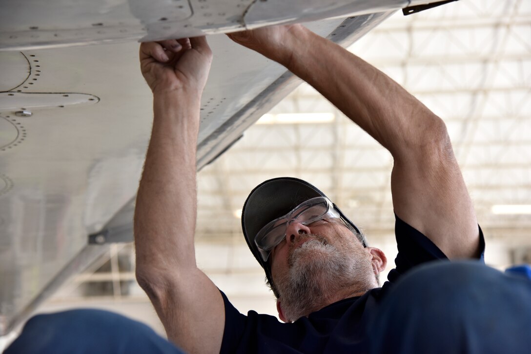 Ray Winkle, a 47th Maintenance Directorate T-1A Jayhawk phase inspection crew, installs an aircraft panel at Laughlin Air Force Base, Texas, April 11, 2019. According to John Jasper, 47th Maintenance Directorate T-1 division chief, there has been a 58 percent personnel turnover since the hail storm of 2016. (U.S. Air Force photo by Senior Airman John A. Crawford)