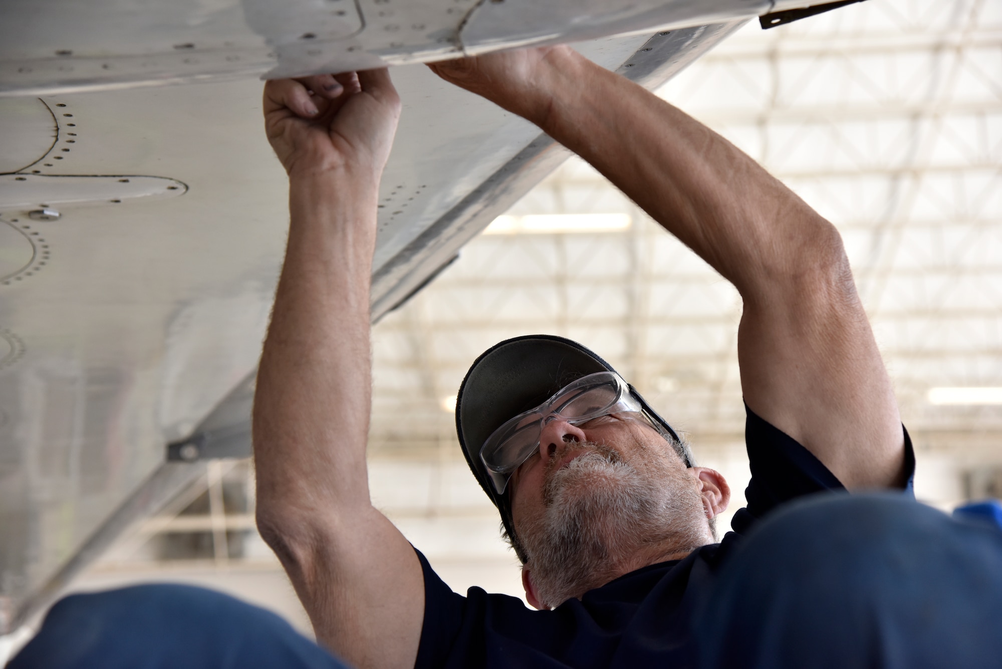 Ray Winkle, a 47th Maintenance Directorate T-1A Jayhawk phase inspection crew, installs an aircraft panel at Laughlin Air Force Base, Texas, April 11, 2019. According to John Jasper, 47th Maintenance Directorate T-1 division chief, there has been a 58 percent personnel turnover since the hail storm of 2016. (U.S. Air Force photo by Senior Airman John A. Crawford)