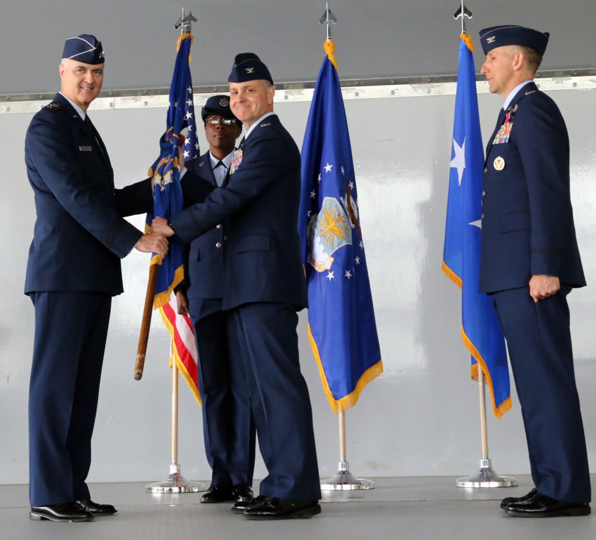 U.S. Air Force Col. Mark Wootan (center) receives the CAP-USAF guidon, emblematic of command, from Lt. Gen. R. Scott Williams, Commander, Continental U.S. North American Aerospace Defense Command Region –1st Air Force (Air Forces Northern). At their left is Wootan’s predecessor as CAP-USAF commander, Col. Michael Tyynismaa. (CAP-USAF courtesy photo)