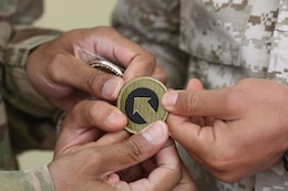A Jordanian Soldier is presented with a 1st Theater Sustainment Command patch following the the United States Army and Jordan Armed Forces noncommissioned officer subject matter expert exchange in Amman, Jordan, April 6-10, 2019. Topics included the enlisted force structure, promotions, professional military education, performance feedback, evaluation processes, and career development for both armies. The U.S. and Jordan remain committed to a strong bilateral relationship built on common interests and mutual respect.