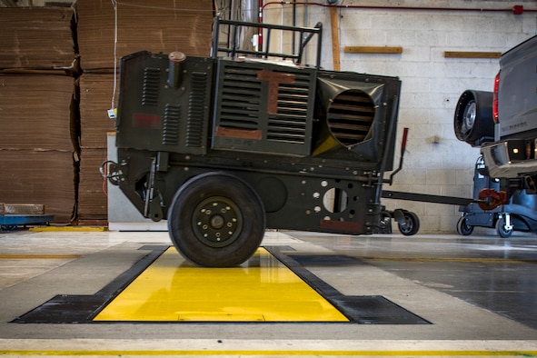 The 92nd Logistics Readiness Squadron utilizes the newly implemented Weigh-In-Motion scale to expedite cargo deployment functions with a more accurate and efficient process at Fairchild Air Force Base, Washington, April 17, 2019. This innovation reduces the entire process to be as simple as driving over a plate in the ground to display the weight, dimensions and center of balance in one step. U.S. Air Force photo by Airman 1st Class Whitney Laine)