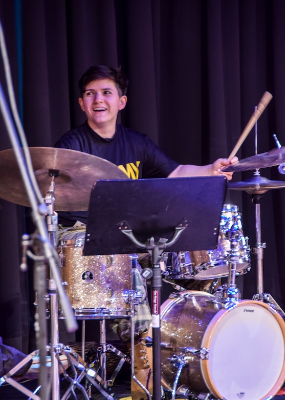 U.S. Army Reserve Spc. Laura Crespo, a bandsman for the 78th Army Band, performs with the 78th Army Band Jazz Combo for the West End House Boys and Girls Club in Allston, Massachusetts, April 12. Musicians perform in a variety of ensembles ranging from ceremonial band to jazz band to small ensembles, playing all styles of music. They are primarily responsible for performing and rehearsing as a professional musician within different ensembles of an Army band.