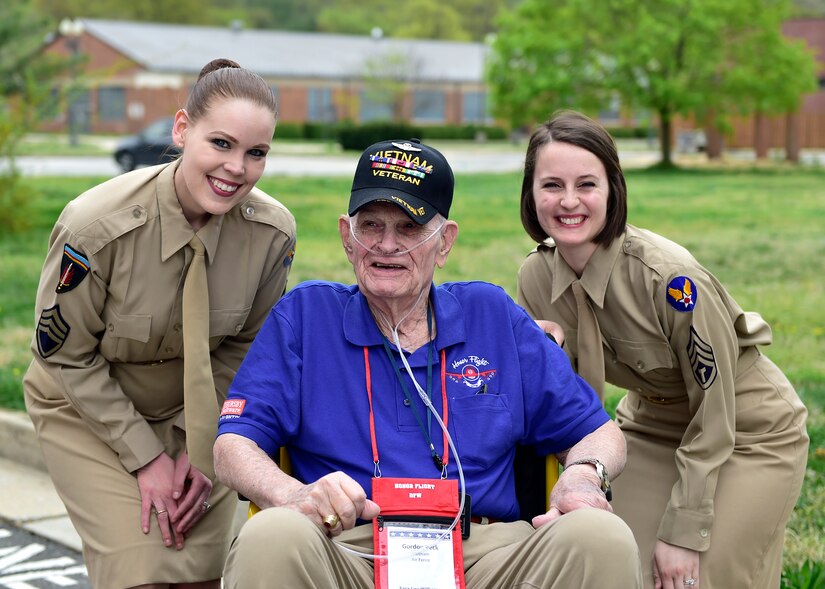 Tech. Sgt. Ashley Keeks and Tech. Sgt. Adrienne Kling, U.S. Air Force Singing Sergeants sopranos, pose with a retired Vietnam veteran before a DFW Honor Flight concert, at Joint Base Anacostia-Bolling, April 13, 2019. The USAF Concert Band and Singing Sergeants honored military veterans from WWII, Vietnam and Korean War by playing music from the era. (U.S. Air Force photo by Staff Sgt. Cary Smith)