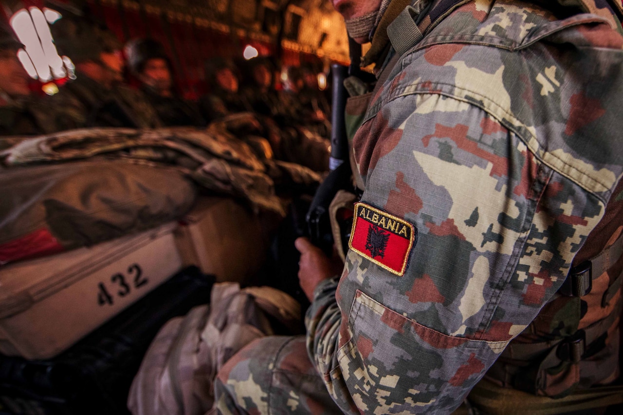 The patch of Albania is visible on a soldier’s sleeve.