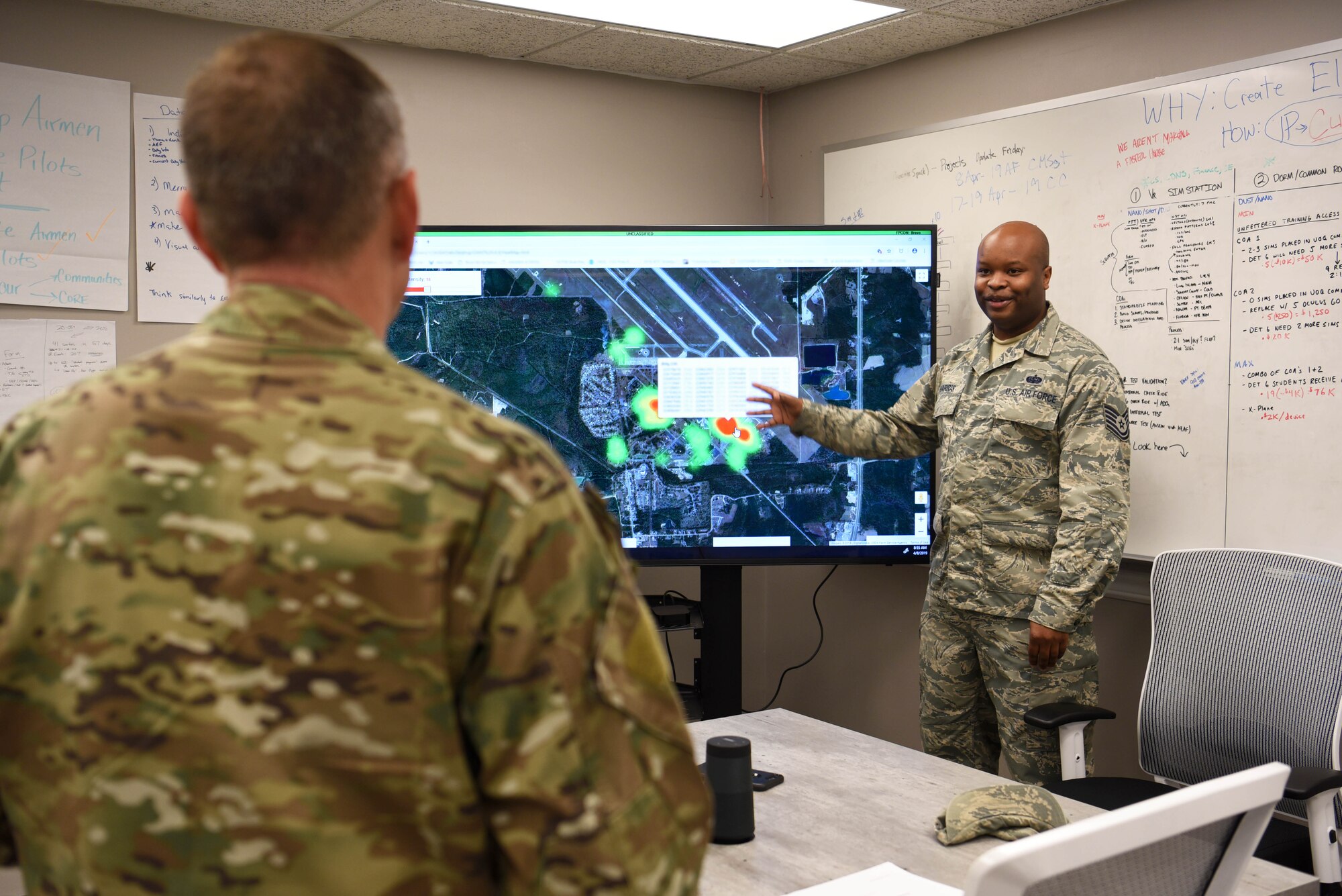 Tech. Sgt. Quincy Harris, 14th Communications Squadron section chief, speaks about Spark Cell innovations helping their unit with 19th Air Force Command Chief Master Sgt. Erik Thomson April 8, 2019, on Columbus Air Force Base, Mississippi. In the visit to the Spark Cell different project leads mentioned the collaborative work from numerous bases, units, and individuals. (U.S. Air Force photo by Airman 1st Class Keith Holcomb)