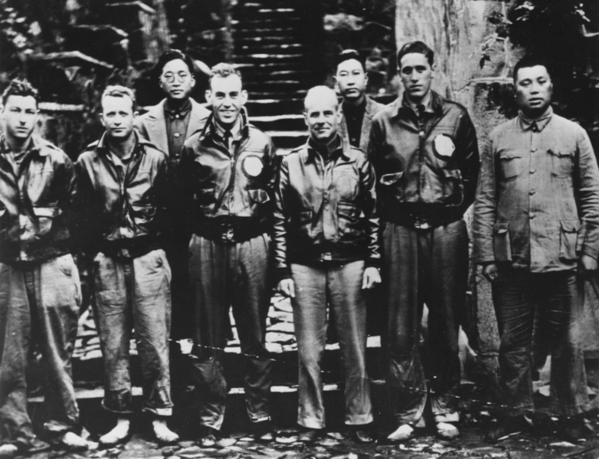 Doolittle (center) with members of his crew and Chinese officials following their bailout near Quzhou, China.  On 18 April 1942, airmen of the US Army Air Forces, led by Lt. Col. James H. (Jimmy) Doolittle, carried the Battle of the Pacific to the heart of the Japanese empire with a surprising and daring raid on military targets at Tokyo, Yokohama, Yokosuka, Nagoya, and Kobe. This heroic attack against these major cities was the result of coordination between the Army Air Forces and the US Navy, which carried the sixteen North American B-25 medium bombers aboard the carrier USS Hornet to within take-off distance of the Japanese Islands. Here, a pair of alert escorts follow the USS Hornet to protect her lethal cargo of B-25 bombers. (Courtesy Photo)