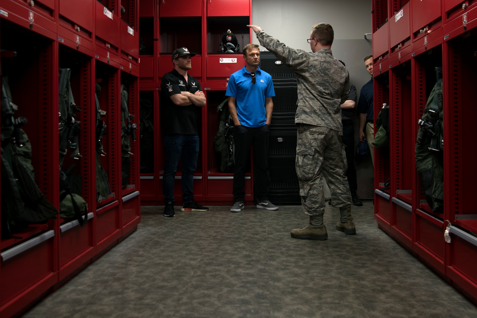 U.S. Air Force Airman 1st Class Carson Buice, 20th Operations Support Squadron aircrew flight equipment technician, speaks to visitors in the 77th Fighter Squadron life support section at Shaw Air Force Base, S.C., April 15, 2019.