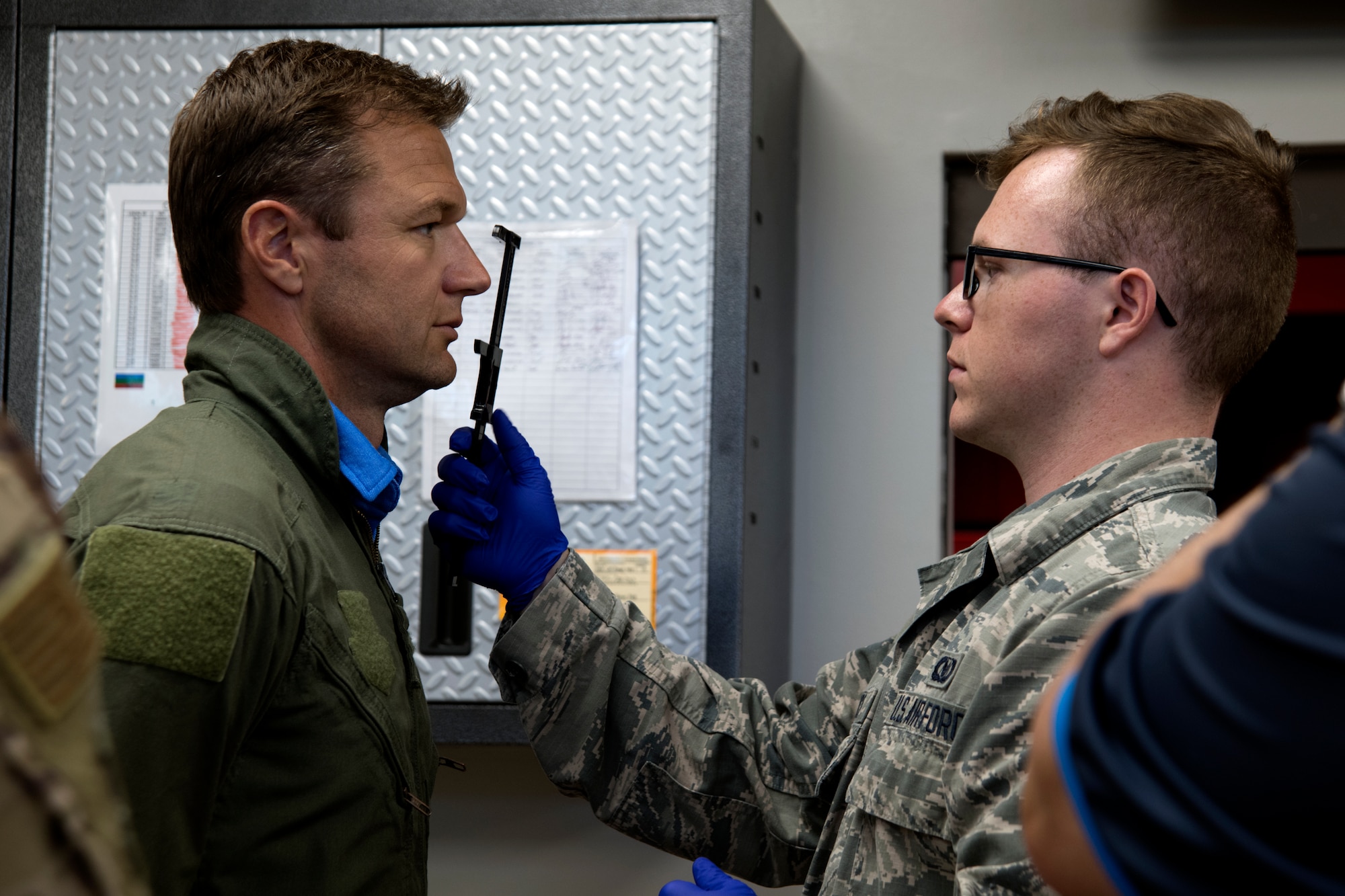 U.S. Air Force Airman 1st Class Carson Buice, 20th Operations Support Squadron aircrew flight equipment technician, takes measurements of Townsend Bell, sports commentator and professional race car driver, at Shaw Air Force Base, S.C., April 15, 2019.