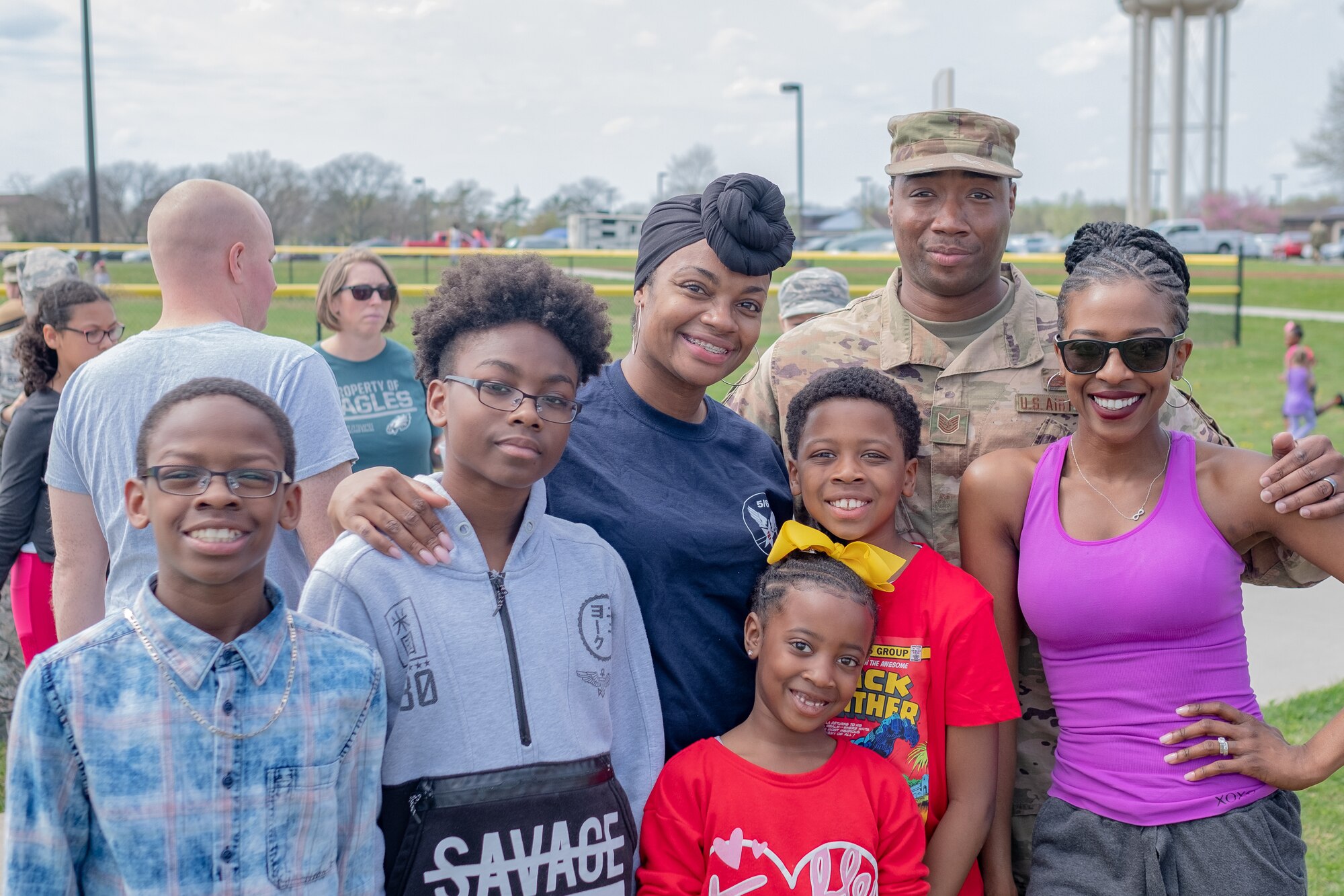 Active duty and Reserve Airmen with the 87th Air Base Wing and the 514th Air Mobility Wing, both located here, pose with their families by the softball quarts on April 18, 2019. The 514th is an Air Force Reserve Command unit located at Joint Base McGuire-Dix-Lakehurst, N.J.