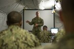 150219-N-HA376-027 . (Feb. 26, 2015) - Lt. Cmdr. Michael Guzzi briefs the 30th Naval Construction Regiment’s (30 NCR) operational planning team prior to a command post exercise (CPX). The CPX was held to test 30 NCR’s staff in real-world decision making, planning and communications in order to coordinate operations.