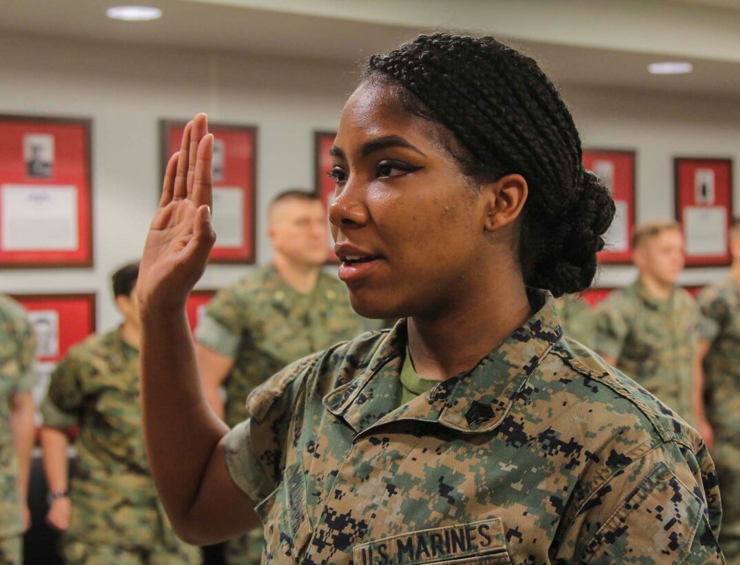 CAMP HUMPHREYS, Republic of Korea – Sergeant Daejahne E. Williams, U.S. Marine Corps Forces Korea administrative specialist, recites the oath of enlistment during her reenlistment ceremony here, Apr. 17. Williams has dedicated another four years of her life to the Marine Corps, choosing to follow in the footsteps of her parents who retired from the Marine Corps after dedicating more than 55 years of combined service. (Official Marine Corps photos by Sgt. Nathaniel Hanscom/Released)