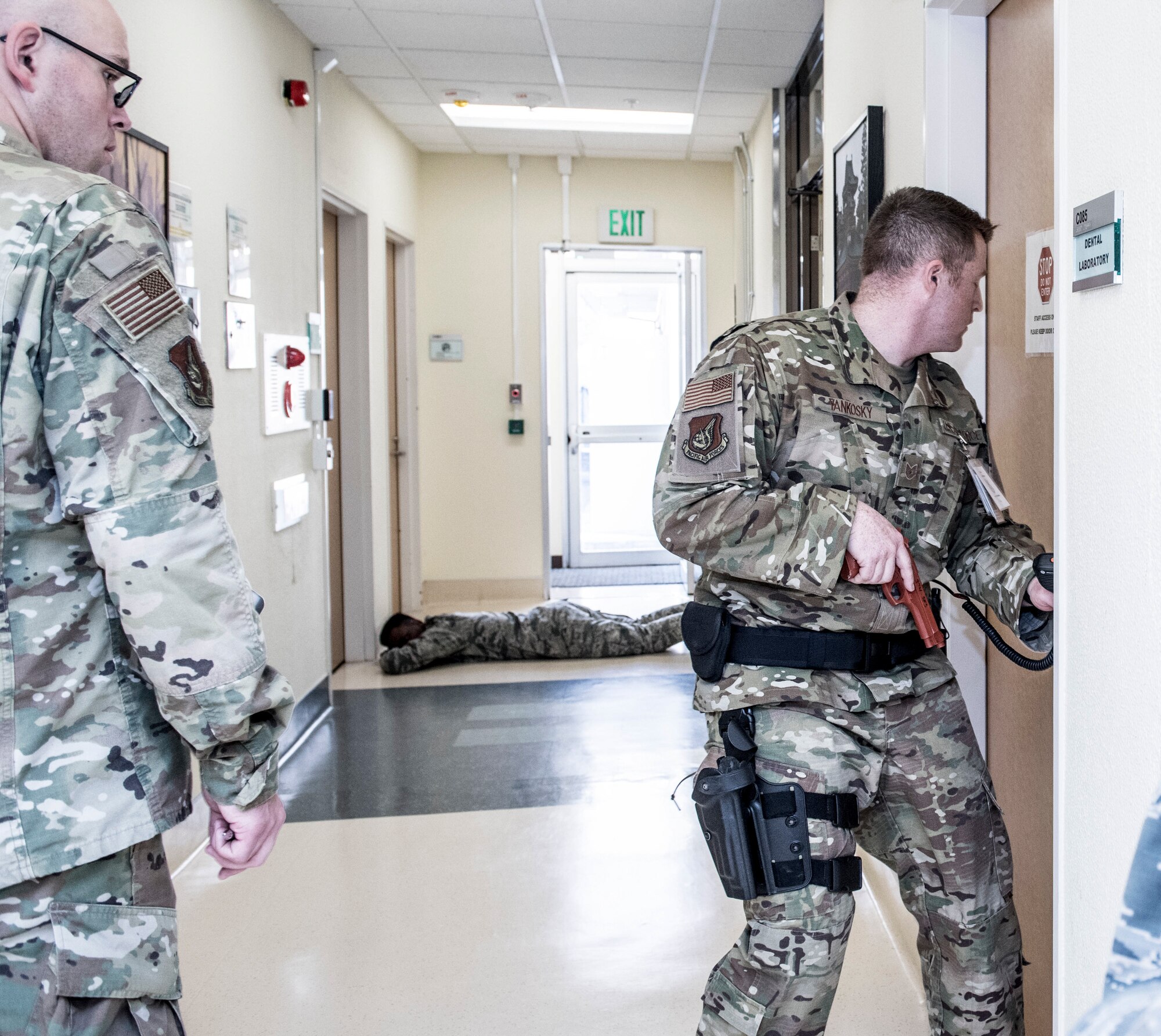 Tech. Sgt. Nick Yankosky, 374th Medical Support Squadron hospital operation section chief, checks rooms for bystanders during an active shooter exercise at Yokota Air Base, Japan, April 18, 2019.