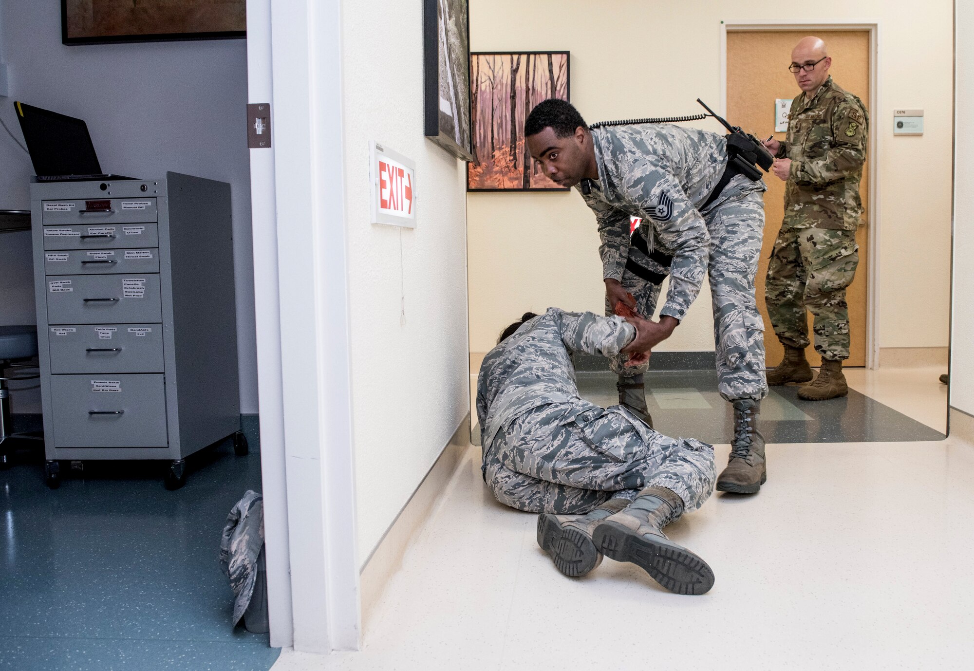 Tech.Sgt. Timothy Wright, 374thDental Squadron dental hygienist, evacuates simulated wounded victim to shelter during an active shooter exercise at Yokota Air Base, Japan, April 18, 2019.