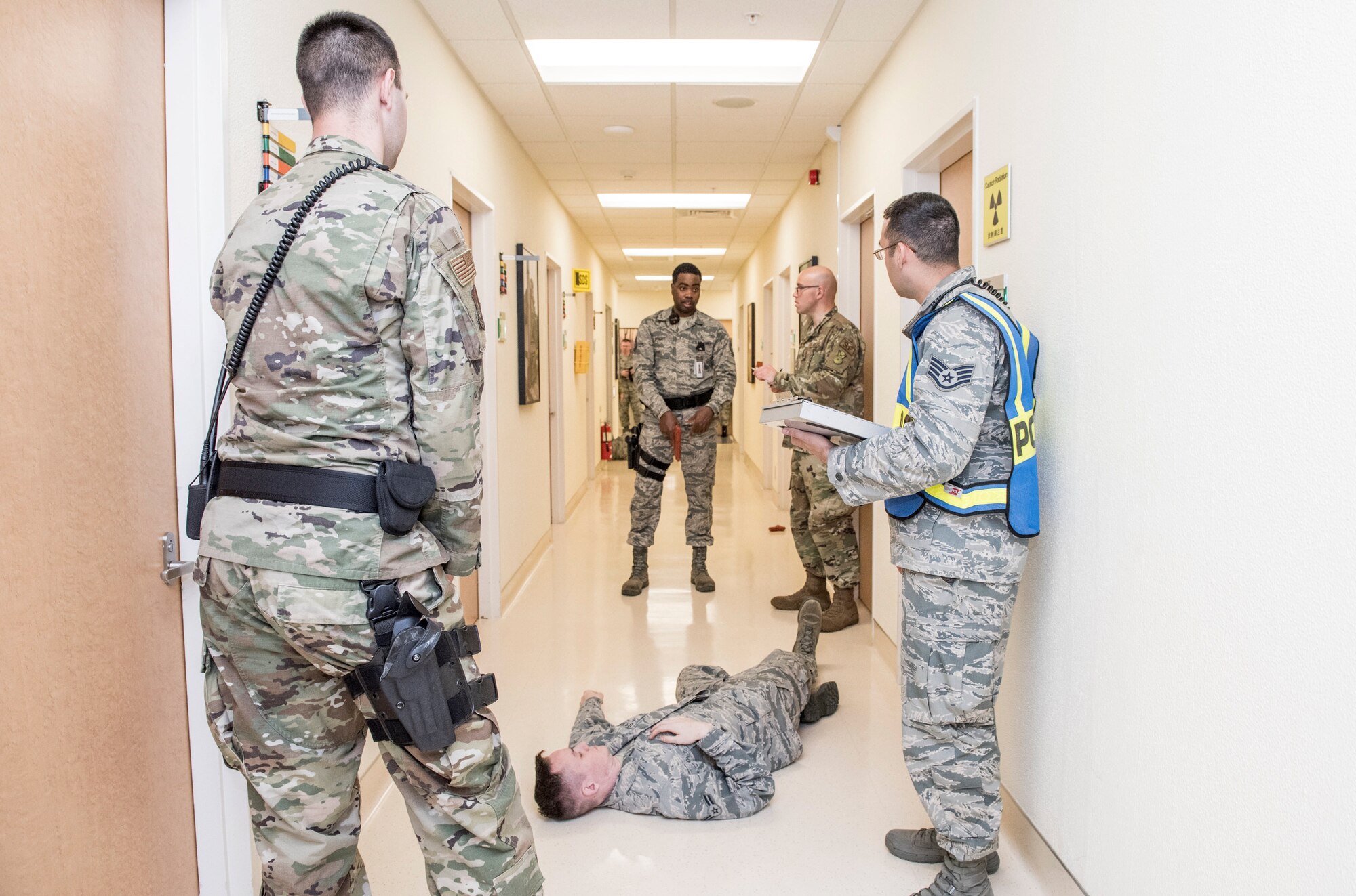 Trainers and evaluators from 374th Security Forces Squadron ask question about their performance to 374th Medical Group Unit Marshals after the test during an active shooter exercise at Yokota Air Base, Japan, April 18, 2019.