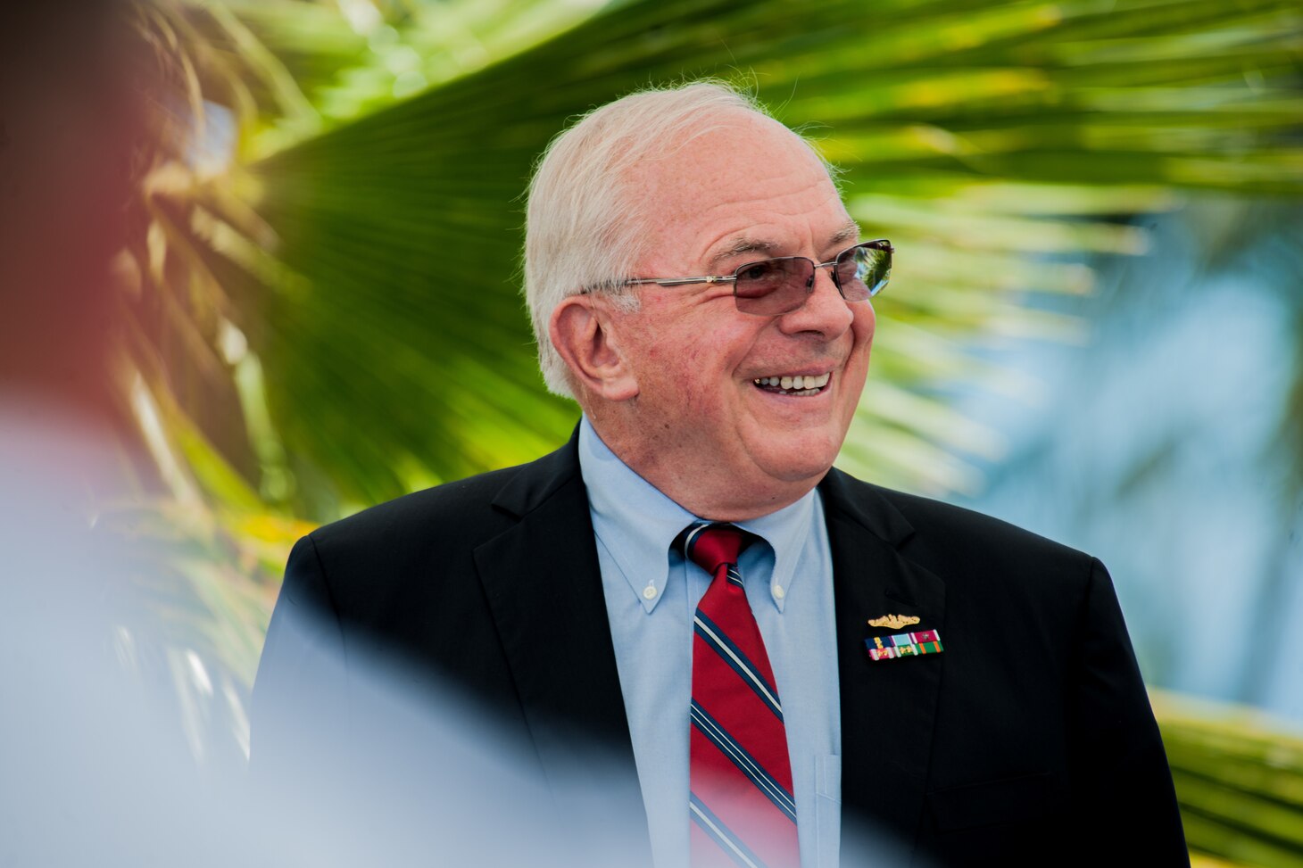 Retired Vice Adm. Albert Konetzni laughs at jokes from his former colleagues describing his historic moments as Pacific Fleet Force submarine commander during the Konetzni Hall building dedication ceremony held at Commander, Submarine Squadron 15 headquarters building. As the Pacific Fleet Force submarine commander, Konetzni spearheaded the squadron's reactivation in 2002, forward-deploying three Los Angeles-class fast attack submarines out of Guam.