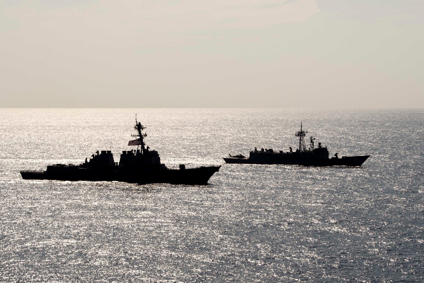 PHILIPPINE SEA (April 18, 2019) The Arleigh Burke-class guided-missile destroyer USS Preble (DDG 88) and the Royal Australian Navy Adelaide-class guided-missile frigate HMAS Melbourne (FFG 05) transit in formation during a cooperative deployment. Preble and Melbourne are participating in a cooperative deployment in order to improve on maritime capabilities between partners.  Preble is deployed to the U.S 7th Fleet area of operations in support of security and stability in the Indo-Pacific region.