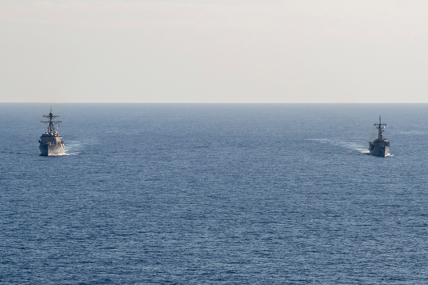 PHILIPPINE SEA (April 18, 2019) The Arleigh Burke-class guided-missile destroyer USS Preble (DDG 88) and the Royal Australian Navy Adelaide-class guided-missile frigate HMAS Melbourne (FFG 05) transit in formation during a cooperative deployment. Preble and Melbourne are participating in a cooperative deployment in order to improve on maritime capabilities between partners.  Preble is deployed to the U.S 7th Fleet area of operations in support of security and stability in the Indo-Pacific region.