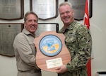 Military Sealift Command (MSC) Capt. Peter Lenardson, master aboard the rescue and salvage ship USNS Salvor (T-ARS 52), left, accepts the 2018 MSC Maritime Excellence Award from U.S. Navy Capt. Robert Williams, commodore, MSC Far East, at MSC Far East headquarters. The Maritime ‘E’ is presented annually to government owned and operated ships for attaining the highest standards of readiness. Salvor regularly conducts salvage, diving, towing, offshore firefighting, heavy-lift operations and theater-security cooperation missions. It is one of only two rescue and salvage vessels in the MSC inventory, and the only ship of its kind in the Far East.