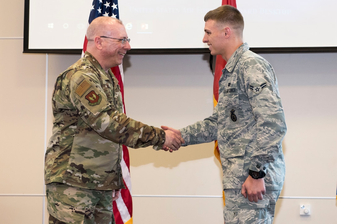 t. Col. Robert LaMore, 39th Air Base Wing inspector general, presents a coin to Airman 1st Class James Cline, 39th Security Forces Squadron modern facility operator, April 17, 2019, at Incirlik Air Base, Turkey.