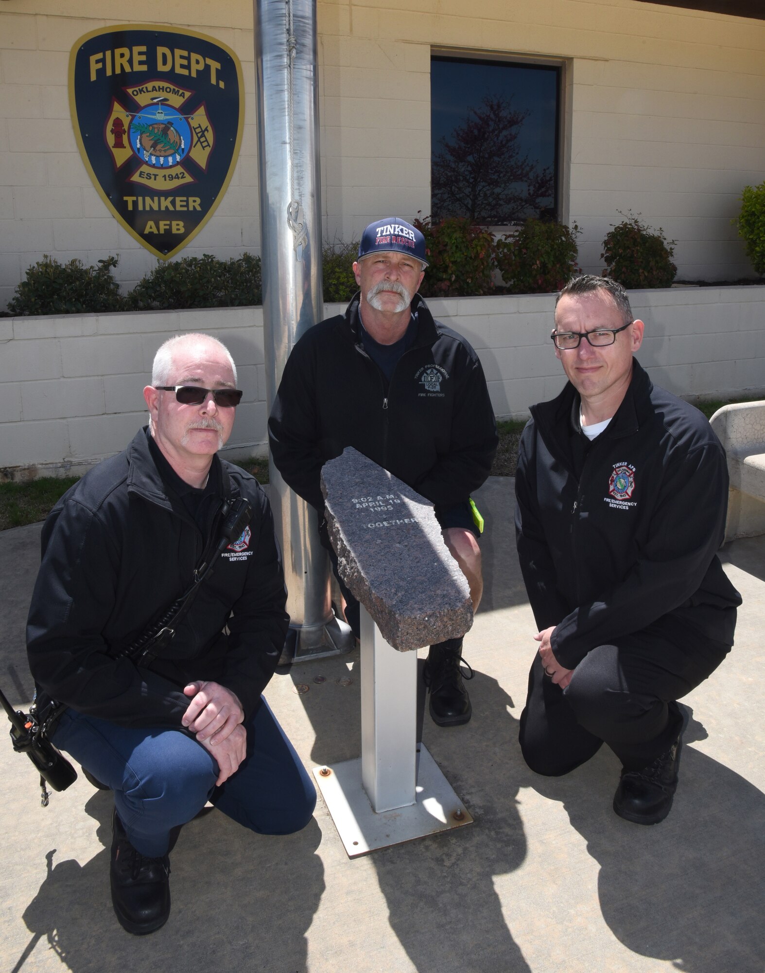 Maj. Bradley Vance, Capt. Justin Dulworth and Capt. Jimmy Westervelt, with Tinker Fire and Emergency Services, were all some of the first responders to the bombing of the Alfred P. Murrah Federal Building on Apr. 19, 1995. Running on adrenaline and pure instinct, the men's main focus was just to help in any way they could in search and recovery and decontamination processes. They are the last three full-time firefighters at Tinker who responded to the disaster. Here, they are pictured with a piece of granite from the Murrah building which is displayed in front of Fire Station 1. (U.S. Air Force photo/Kelly White)