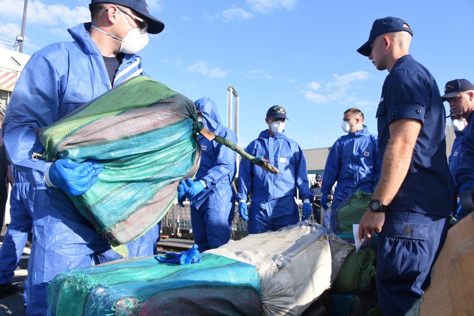 Coast Guard Cutter Bear (WMEC-901) crewmembers stage interdicted drugs on the flight deck of the cutter April 18, 2019 at Port Everglades, Florida.