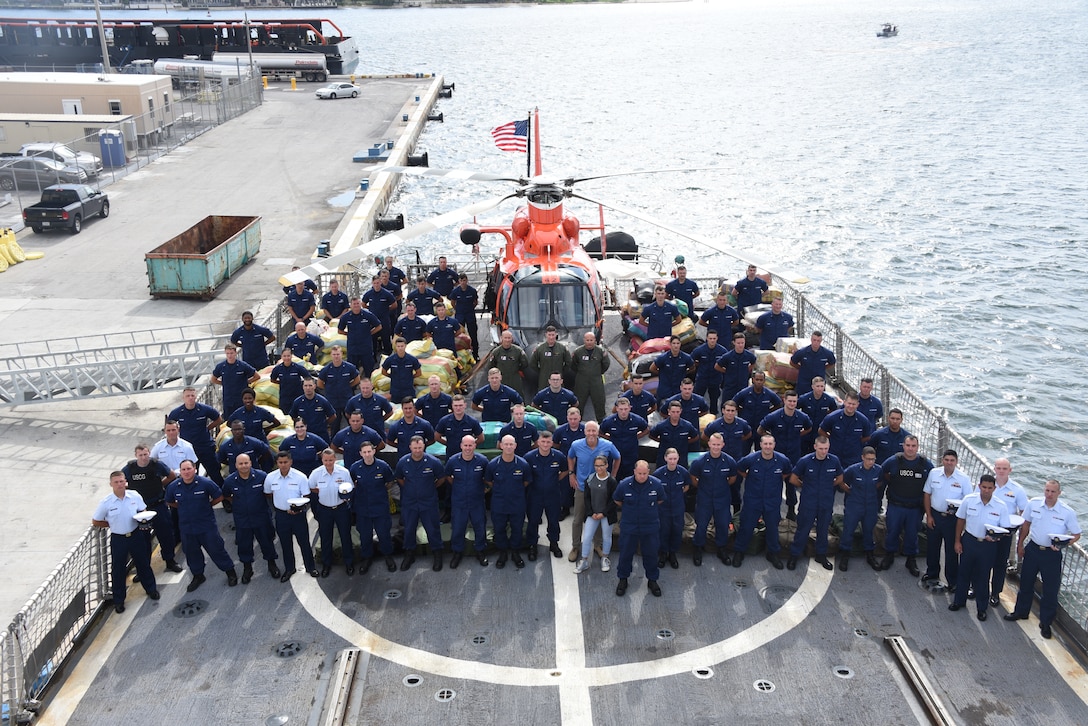 Coast Guard Cutter Bear (WMEC-901) crewmembers stand among interdicted drugs on the flight deck of the cutter April 18, 2019 at Port Everglades, Florida.