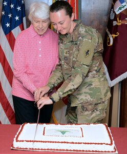 Retired Col. Jessie Breuer and 2nd Lt. Carley Laplant cut the ceremonial Army Medical Specialist Corps cake at the U.S. Army Medical Department Center and School, Health Readiness Center of Excellence, or AMEDDC&S HRCoE, headquarters building at Joint Base San Antonio-Fort Sam Houston April 16.