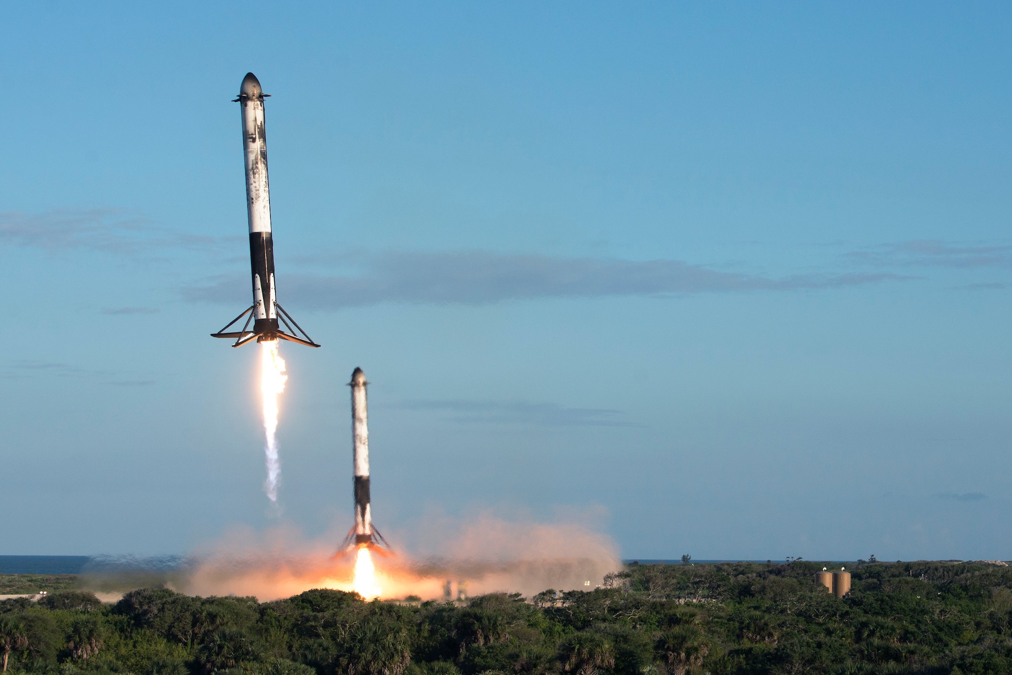 Two reusable rocket boosters land after the successful launch of SpaceX's Falcon Heavy Arabsat 6A