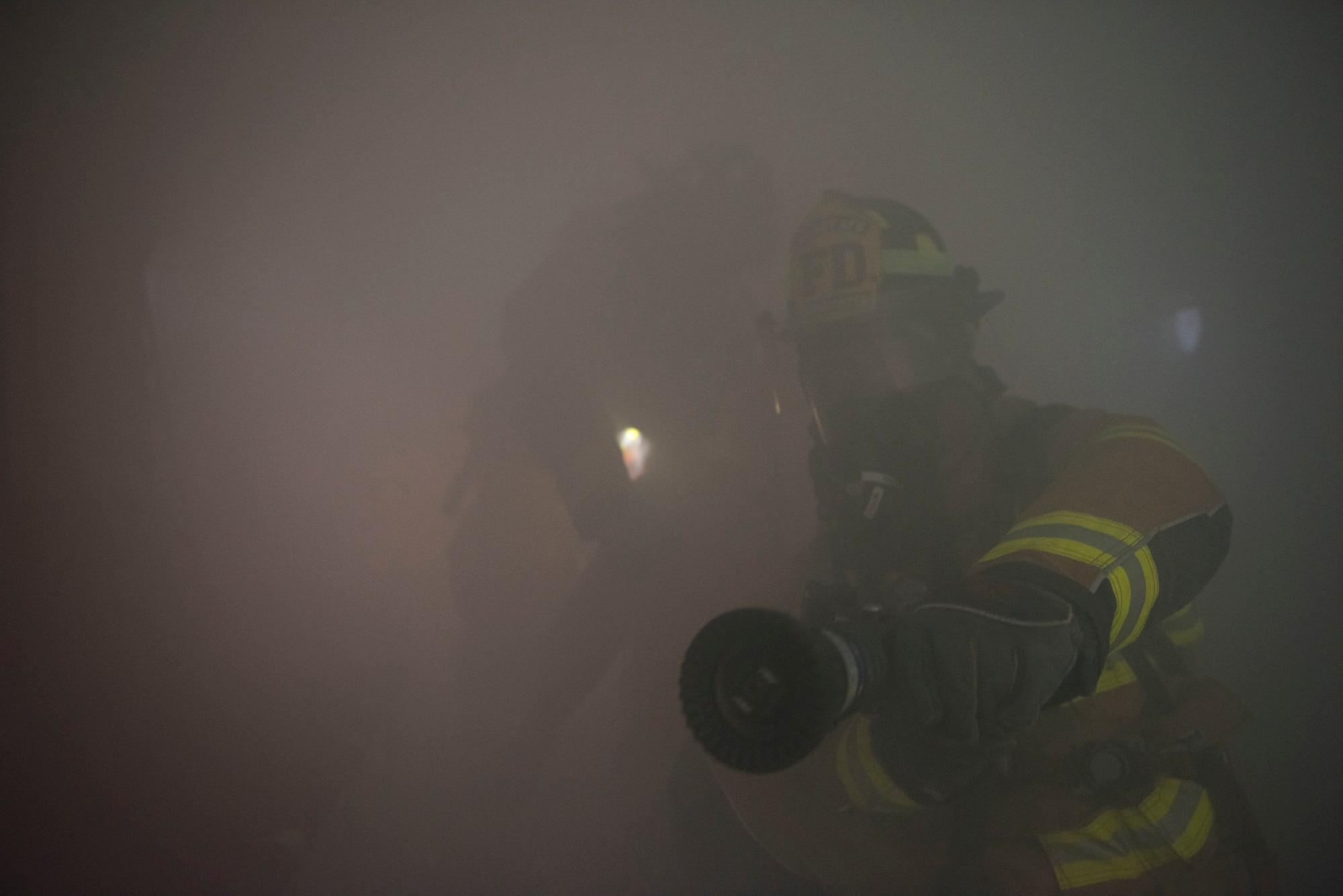 Airmen simulate extinguishing a fire
