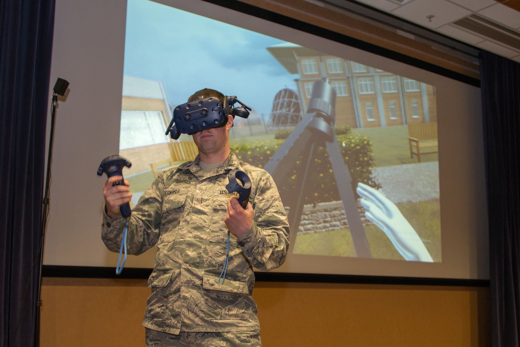 Capt. Matthew Perkins, 1st Weather Group science officer, sets up a tripod in virtual reality during a product handover March 14, 2019, at Offutt Air Force Base, Nebraska. The 1st WXG VR training software allows Airmen to train in locations where equipment may not be readily available and reduces wear and tear on actual equipment. (U.S. Air Force photo by Paul Shirk)
