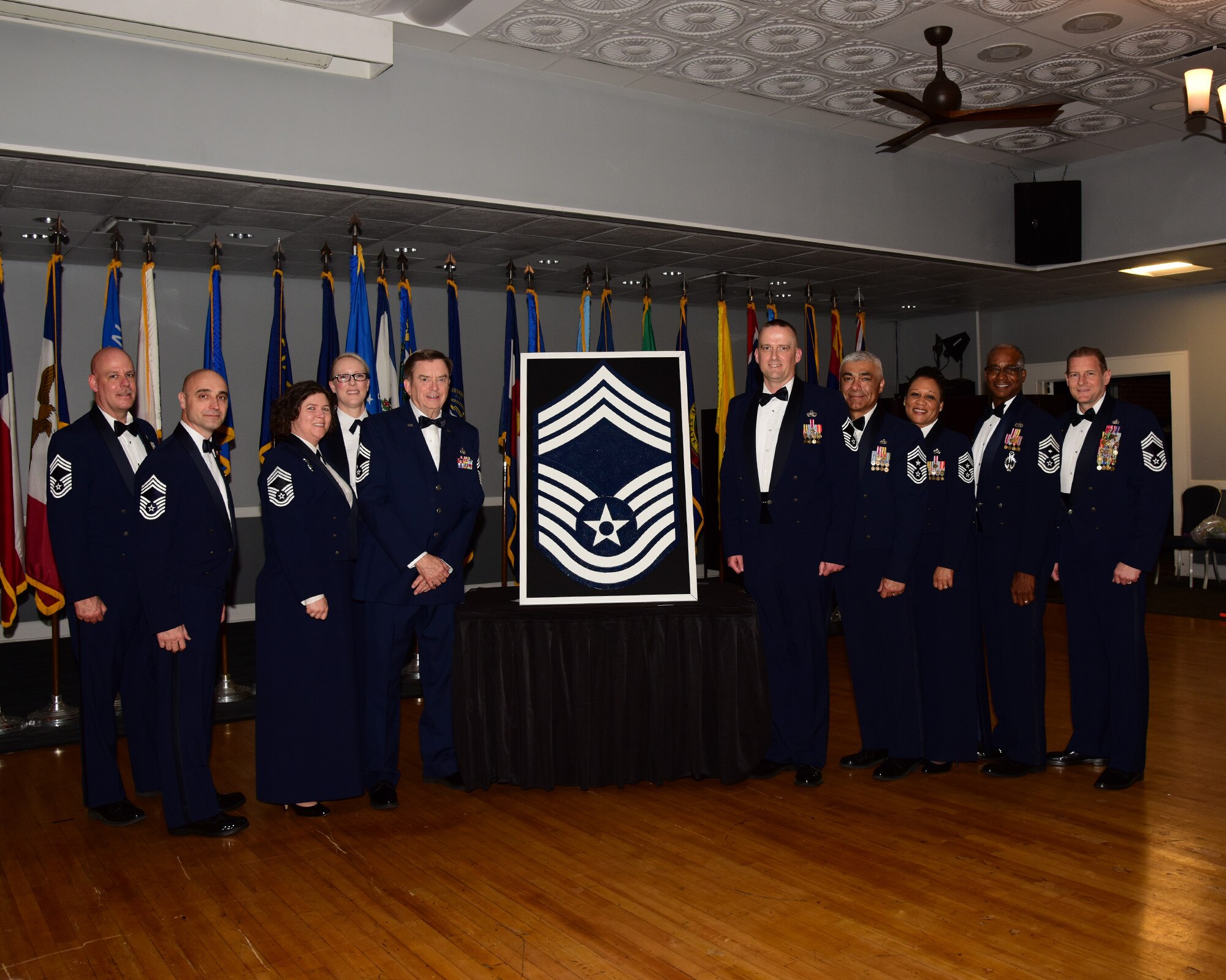 Senior Master Sgt. Wade Steinback, 14th Flying Training Wing Maintenance Authority superintendent, stands with 14th Flying Training Wing chief master sergeants board during a chief recognition ceremony April 12, 2019, at the Club on Columbus Air Force Base, Miss. As the highest ranked enlisted members, chief master sergeants are responsible for mentoring and developing junior enlisted personnel. (U.S. Air Force photo by Melissa Doublin)