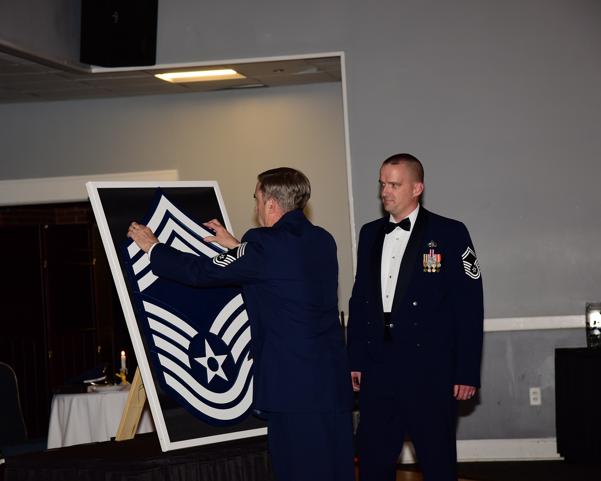 Retired Chief Master Sgt. Dennis Fitzpatrick, Senior Master Sgt. Wade Steinback’s, 14th Flying Training Wing Maintenance Authority superintendent, father-in-law, pins on the chief master sergeant stripe during a chief recognition ceremony April 12, 2019, on Columbus Air Force Base, Miss. Individuals with the rank of chief master sergeant serve in the highest enlisted rank and hold strategic leadership positions with tremendous influence at all levels of the Air Force. (U.S. Air Force photo by Melissa Doublin)