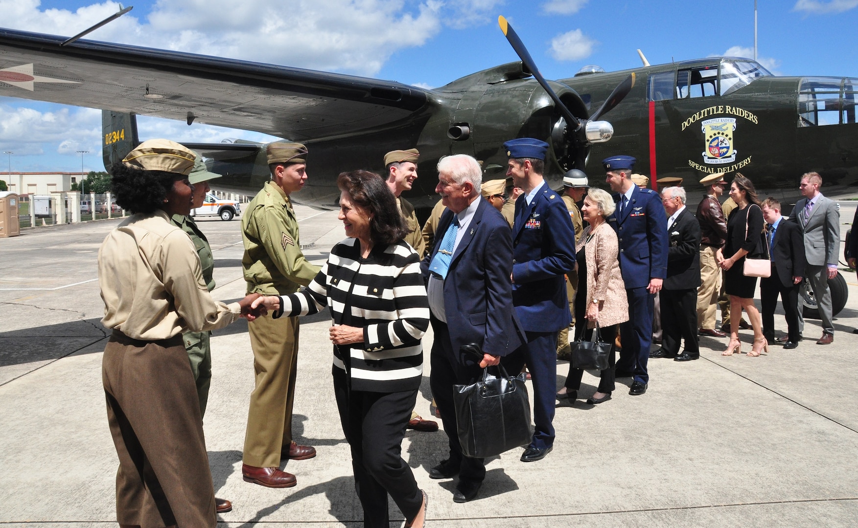 The family of retired U.S. Air Force Lt. Col. Richard “Dick” E. Cole shake hands with Airmen dressed in WWII uniforms at a B-25 Mitchell static display during a memorial service for their father at Joint Base San Antonio-Randolph April 18. Cole, the last surviving Doolittle Raider, was the co-pilot on a B-25 Mitchell for then-Col. Jimmy Doolittle during the storied World War II Doolittle Tokyo Raid.