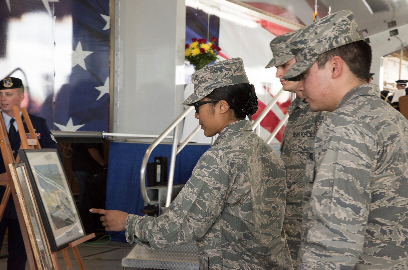 Airmen from Joint Base San Antonio look at original World War II-era artwork before a memorial service for retired U.S. Air Force Lt. Col. Richard “Dick” E. Cole at JBSA-Randolph April 18. Cole, the last surviving Doolittle Raider, was the co-pilot on a B-25 Mitchell for then-Col. Jimmy Doolittle during the storied World War II Doolittle Tokyo Raid and was a founding Airman of the USAF Special Operations community.