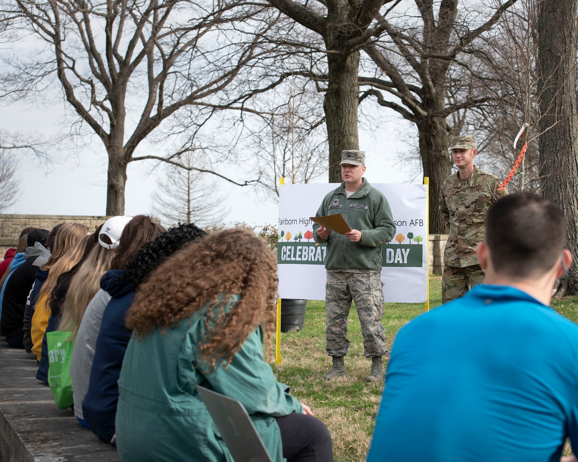 Col. David Anzaldua, 88th Air Base Wing vice commander, reads the Arbor Day proclamation to Fairborn High School environmental advanced placement students on the grounds near the Wright Brothers Memorial, Dayton, Ohio, April 11, 2019. The students participated in Arbor Day activities, including planting a total of 26 trees to support efforts for protecting trees and woodlands. (U.S. Air Force photo by Michelle Gigante)