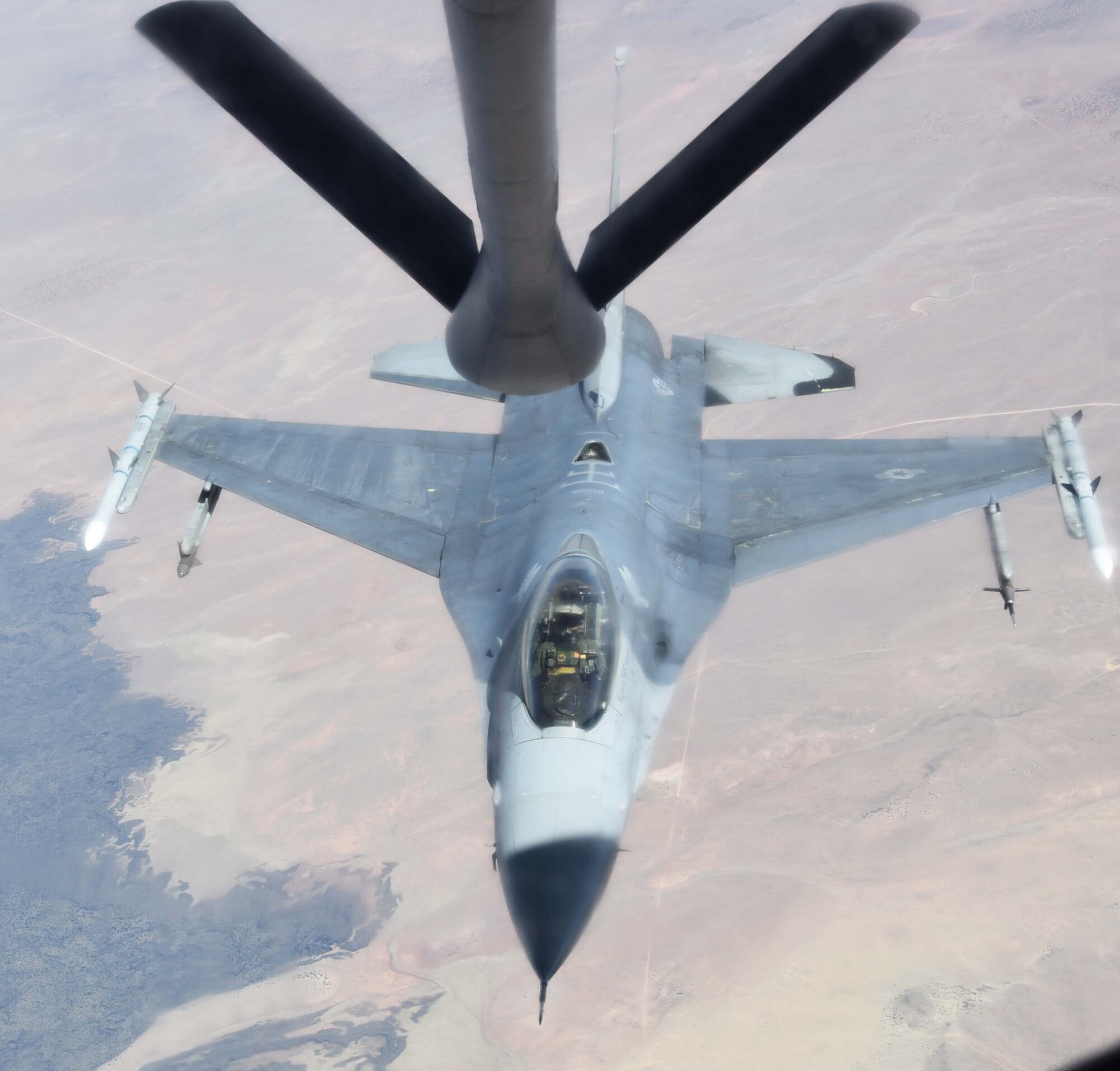 An F-16 Fighting Falcon from the 54th Fighter Squadron out of Holloman Air Force Base, N.M., approaches the boom of a KC-135 Stratotanker from McConnell AFB, Kan., April 9, 2019.  During the flight, the KC-135 crew refueled five total F-16s and made 12 contacts.