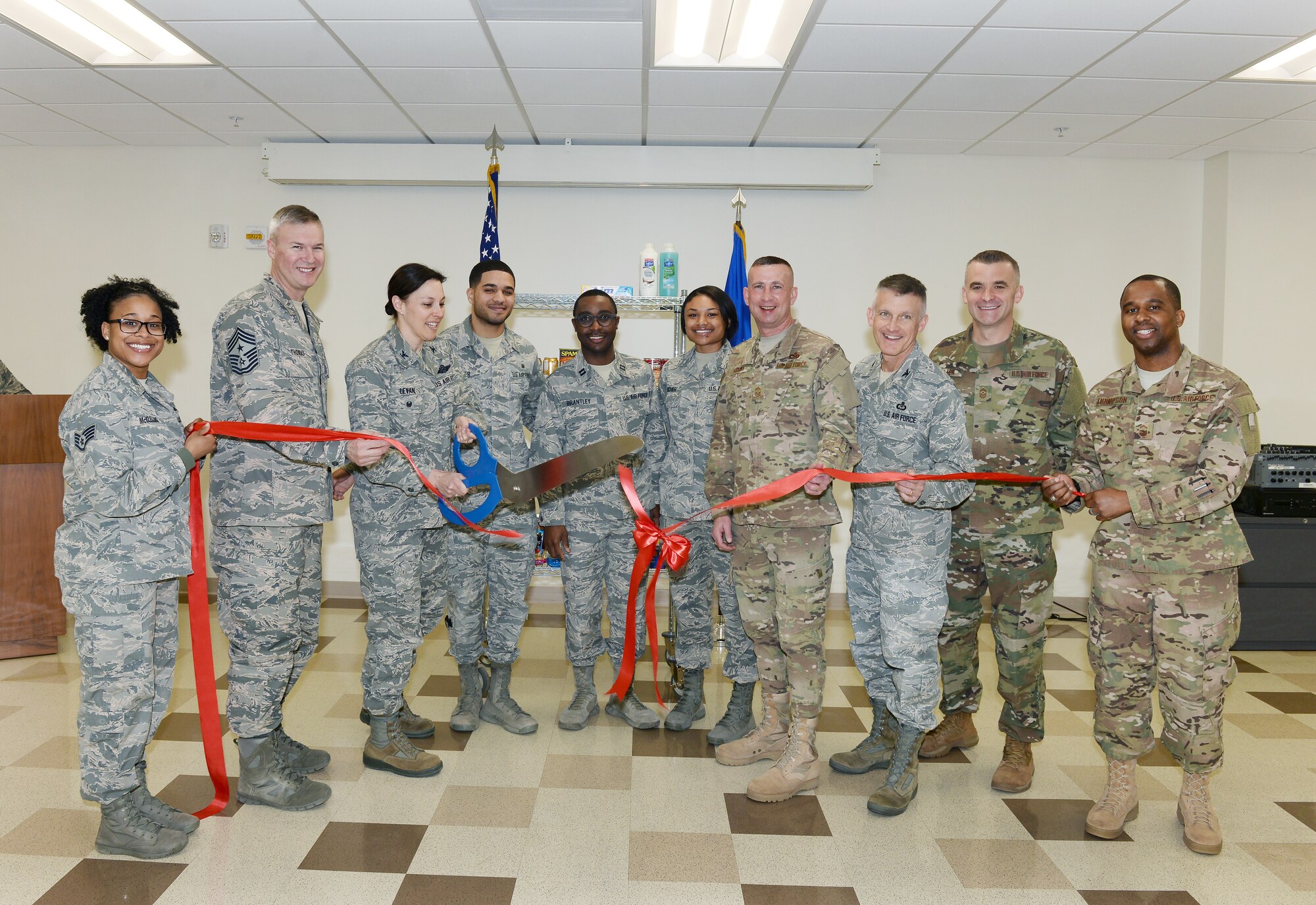 U.S. Air Force Col. Sherri LeVan, 55th Wing vice commander, cuts a ribbon April 15, 2019, during the Offutt Food Pantry ribbon cutting ceremony inside the Ehrling Bergquist Clinic at Offutt Air Force Base, Nebraska. LeVan also gave the opening remarks declaring the importance of the new food pantry helping individuals who are in need. (U.S. Air Force photo by Charles J. Haymond)