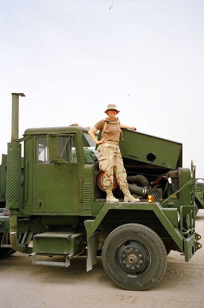 Staff Sgt. Mary Junell stands on her assigned truck while she was serving in Iraq in 2004 with the North Carolina National Guard’s 1450th Transportation Company. The unit spent several months on the roads in Iraq before they were able to get armor on their vehicles; a common occurrence in the early years of Operation Iraqi Freedom.