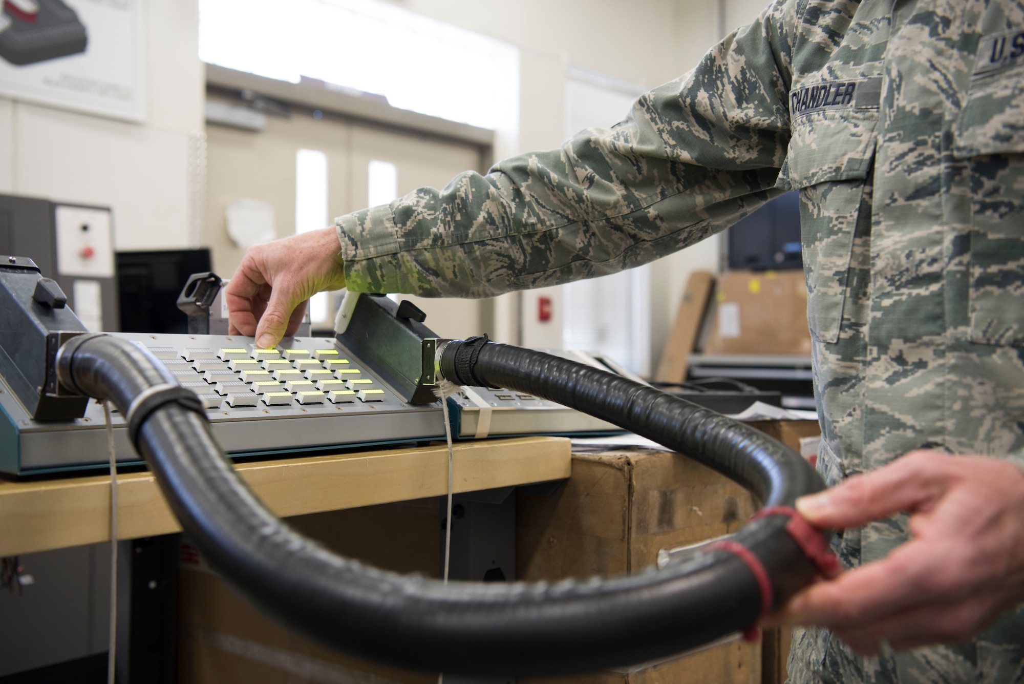 U.S. Air Force Senior Master Sgt. Mike Chandler, 142nd Maintenance Squadron out of the Portland Air National Guard, displays his avionics Electronics Systems Test Station (ESTS) cable tester that he designed. Chandler’s invention a reduces a two hours task to a 30 second task, saving time, money and enhancing readiness.