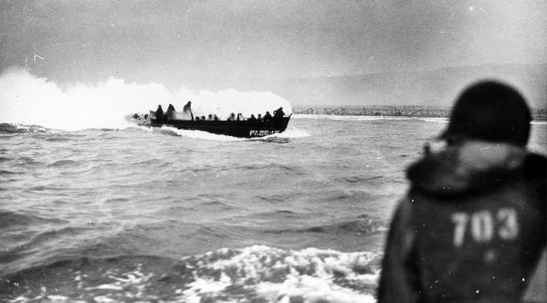 A burning landing craft approaches the Omaha beachhead.