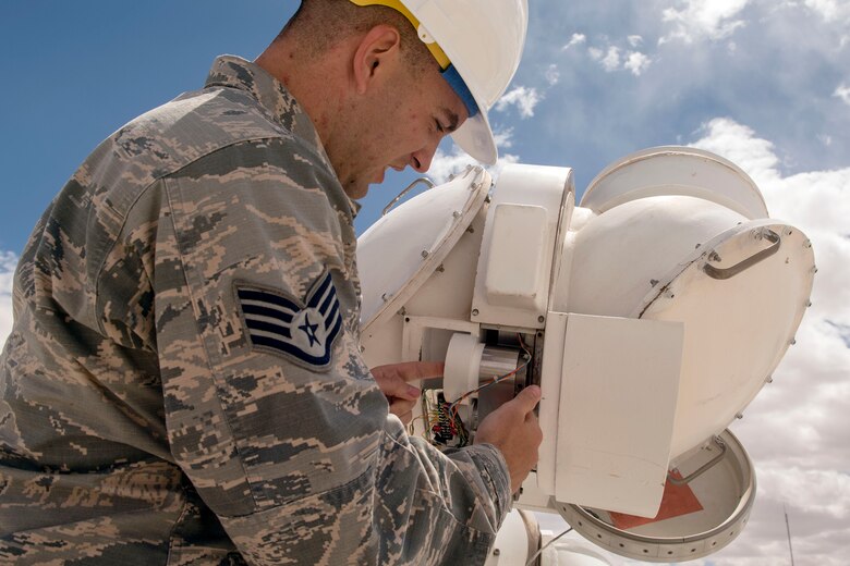 Staff Sgt. Bradley Douglas, 2d Weather Squadron, Detachment 4, central repair activity technician performs an inspection of a declination head April 11, 2019, at the Solar Observatory on Holloman Air Force Base, N.M. The inspection involves verifying the wires are still serviceable and properly connected to the drive gear assembly and gear tachometer. (U.S. Air Force photo by Staff Sgt. Christine Groening)