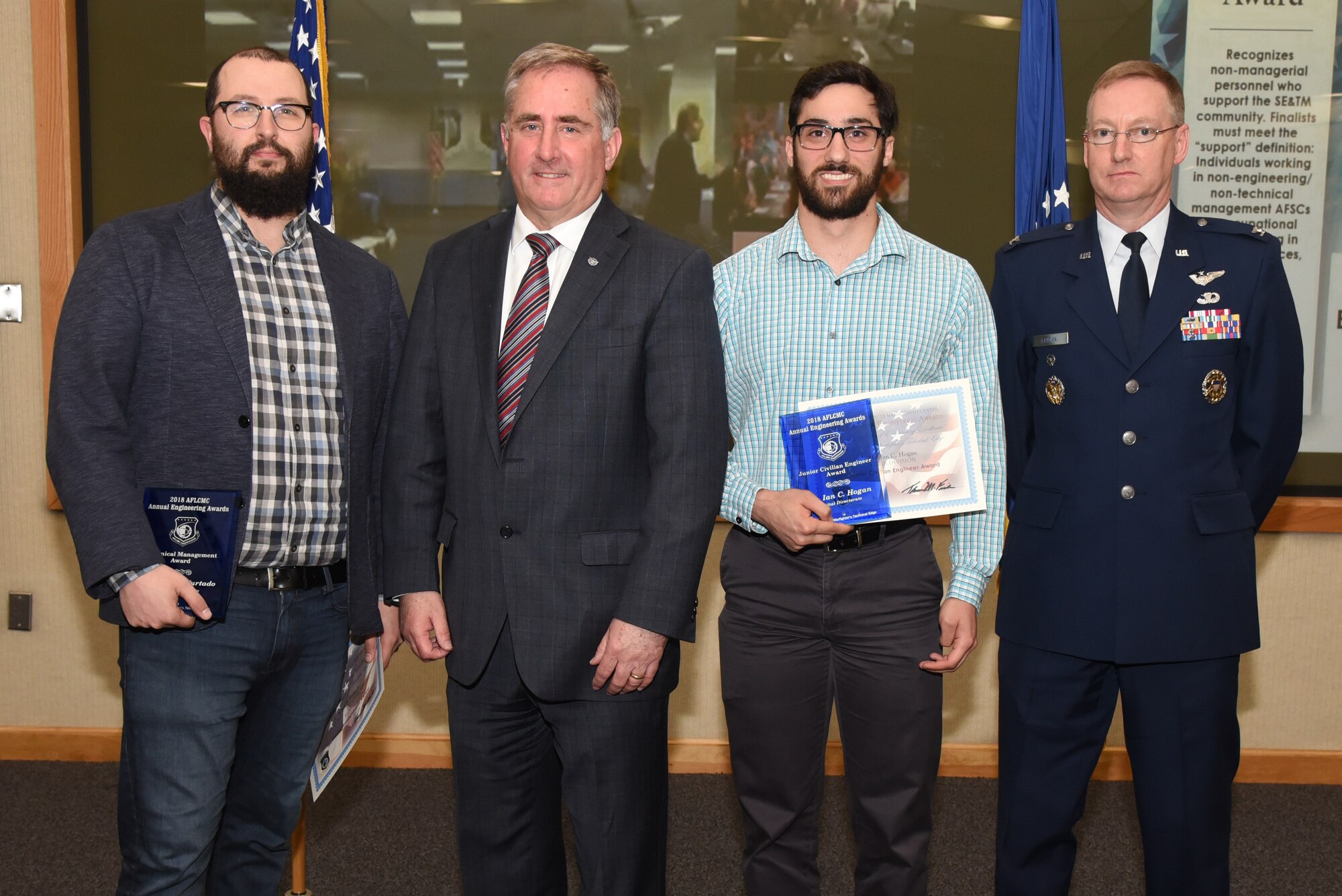 Adam Furtado, lab director of Project Kessel Run stands with Stephen Falcone, Program Executive Office Digital director of engineering, Ian Hogan, a PEO Digital general engineer and Col. Vincent Chioma, deputy associate director of engineering and technical management for Air Force Life Cycle Management Center-Hanscom during the AFLCMC engineering annual awards April 19, 2019 at the Hanscom Conference Center, Hanscom Air Force Base, Mass. Hogan and Furtado both earned awards for their work integrating agile development into software acquisition. (U.S. Air Force photo by Todd Maki)