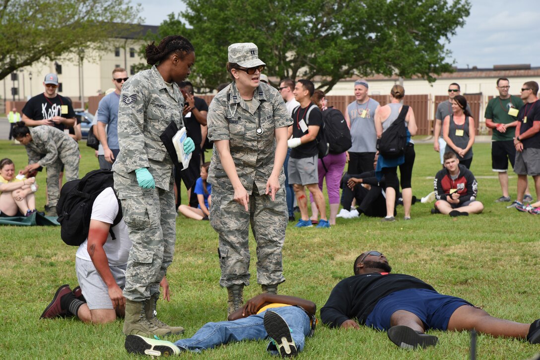 U.S. Air Force Staff Sgt. Erica Jenkins, 81st Medical Operations Squadron family health clinic team lead, and Capt. Jennifer Thomas, 81st Aerospace Medicine Squadron base operational medicine clinic physician assistant, discuss patient triage during a mass casualty and response exercise on Keesler Air Force Base, Mississippi, April 17, 2019. The scenario for the two-day event included a simulated plane crash with debris landing both on and off base in crowds of people. The exercise tested base and local civilian emergency response organizations' ability to operate in a multi-agency and multi-jurisdiction crisis situation. (U.S. Air Force photo by Kemberly Groue)