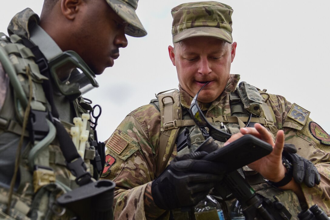 Staff Sgt. Codey Doehrmann, 47th Security Forces Squadron military working dog handler, and Senior Airman James Little, 47th SFS patrolman, discuss a possible route to move on during an exercise at Laughlin Air Force Base, Texas, April 17, 2019. During the defender’s exercise, Doehrmann and the K-9 team lead the pack as they tracked down the simulated opposing force in the farthest reaches of Laughlin’s perimeter. (U.S. Air Force photo by Senior Airman Benjamin N. Valmoja)