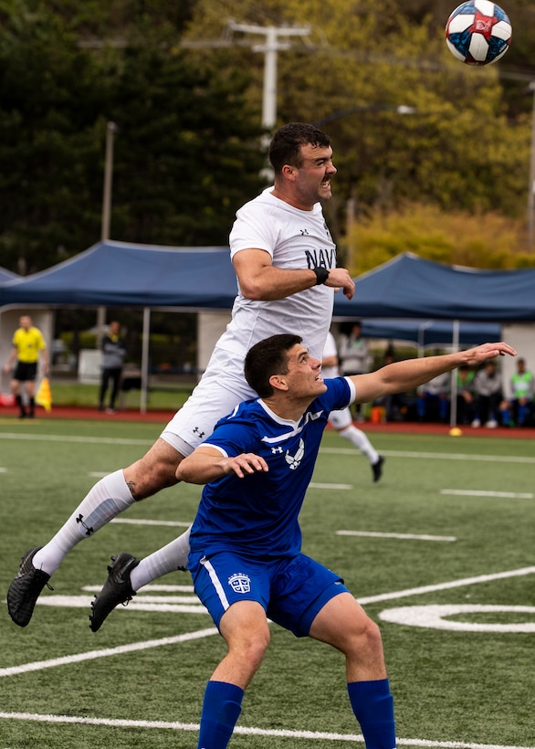 NAVAL STATION EVERETT, Wa. (April 18, 2019) - Petty Officer 2nd Class Michael Williams, stationed at Naval Construction Battalion Center, Gulfport MS., competes for a ball against SSgt. Nicholas Cardenas, stationed at Fort Meade, MD., during the Armed Forces Sports Men’s Soccer Championship hosted at Naval Station Everett. (U.S. Navy Photo by Mass Communication Specialist 2nd Class Ian Carver/RELEASED).