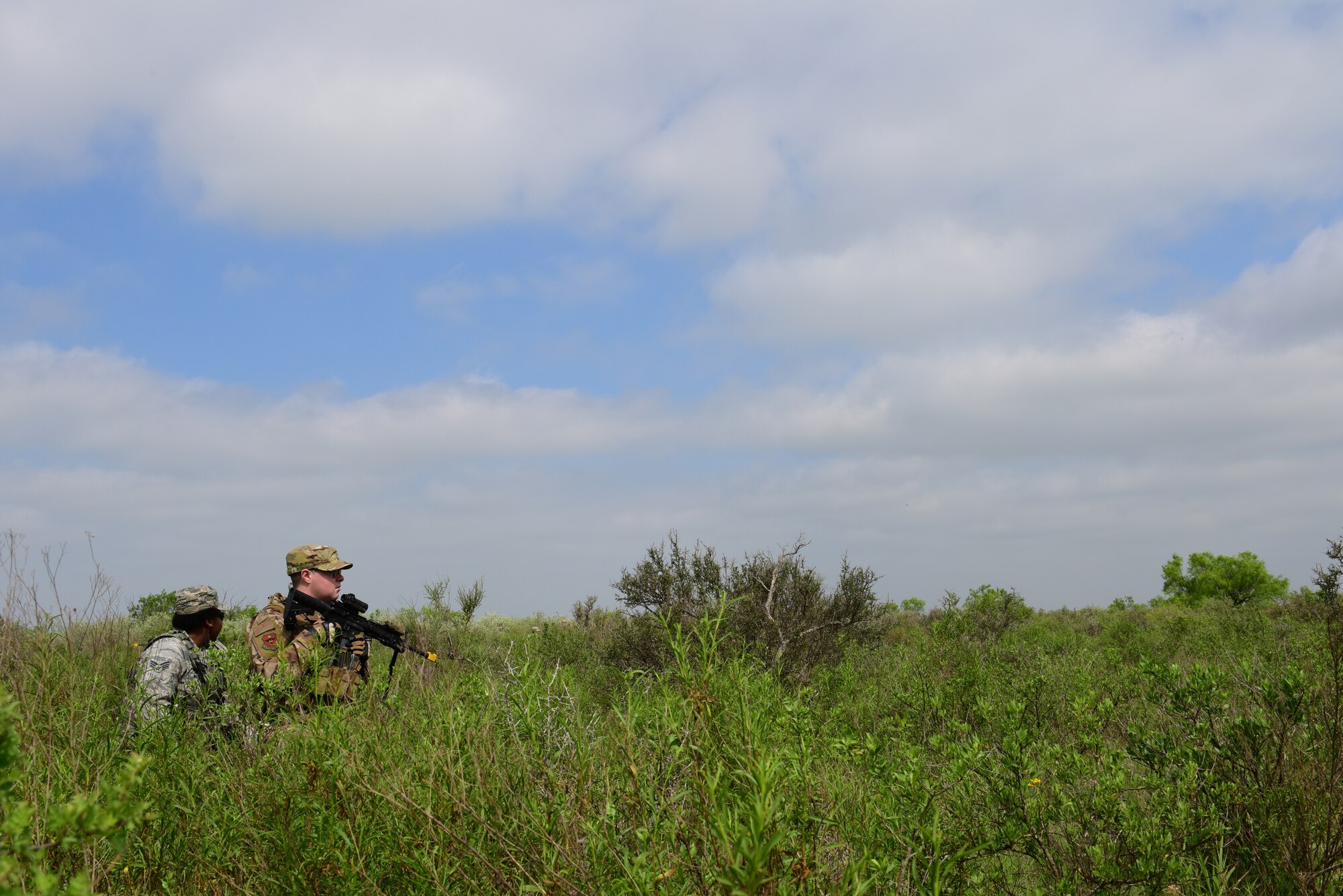 Airman 1st Class Colin Aranza and Senior Airman Samantha Hall, 47th Security Forces Squadron partolmen, keep a watchful eye on their surroundings during an exercise at Laughlin Air Force Base, Texas, April 17, 2019. The 47th SFS changed up the tempo with an exercise that challenged their tactics, teamwork and physical fitness as they were put head to head with a simulated opposing force. (U.S. Air Force photo by Senior Airman Benjamin N. Valmoja)