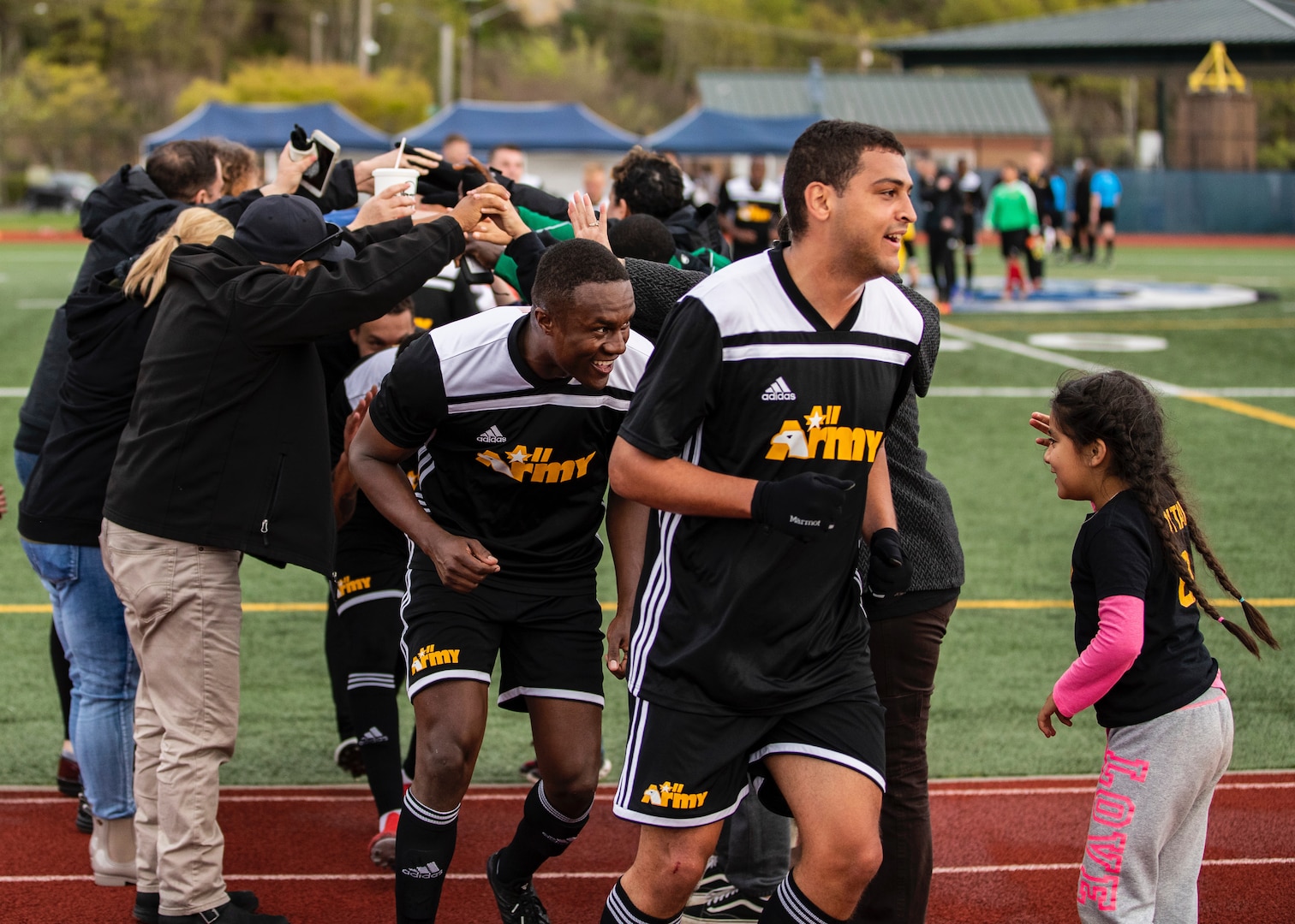 NAVAL STATION EVERETT, Wash. (April 18, 2019) -- Army travels through the tunnel made by their fans after their 3-1 victory over the Marines in the final day of round robin play during the 2019 Armed Forces Men's Soccer Championship.  (U.S. Navy Photo, MC2 Ian Carver/Released)