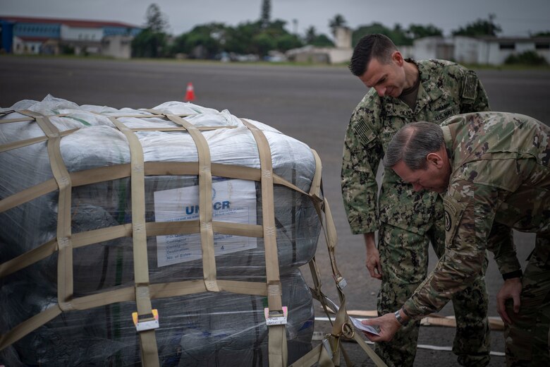 U.S. Army Maj. Gen. James D. Craig, right, commanding general, Combined Joint Task Force-Horn of Africa (CJTF-HOA), and U.S. Navy Cmdr. Brian Patterson look at the weight sheet of a pallet of blankets in Maputo, Mozambique, April 2, 2019. The task force is helping meet requirements identified by the United States Agency for International Development (USAID) assessment teams and humanitarian organizations working in the region by providing logistics support and manpower to USAID at the request of the Government of the Republic of Mozambique. (U.S. Air Force Photo by Tech. Sgt. Chris Hibben)