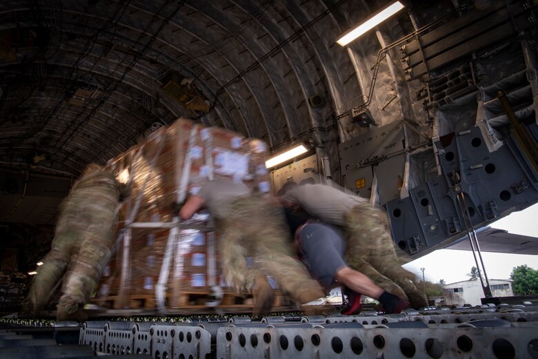 U.S. military personnel load Plumpy Sup on a C-17 Globemaster III assigned to the 16th Airlift Squadron, Joint Base Charleston, Charleston, South Carolina, supporting Combined Joint Task Force-Horn of Africa, in Maputo, Mozambique, April 2, 2019. The task force is helping meet requirements identified by the United States Agency for International Development (USAID) assessment teams and humanitarian organizations working in the region by providing logistics support and manpower to USAID at the request of the Government of the Republic of Mozambique. (U.S. Air Force Photo by Tech. Sgt. Chris Hibben)